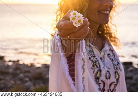 Cheerful Happy Freee Caucasian Middle Age Woman In Hippy Fashion Clothes Take A Beautiful Daisy Flow