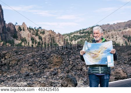 White Hair Old Adult Man Looking And Checking A Paper Map On The Road Of A Walking And Hiking Altern