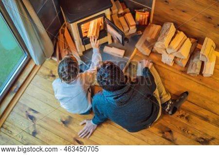 Dad And Son Spend Time By The Fireplace In Glamping. Rest In The Mountains In Glamping. Cozy Firepla