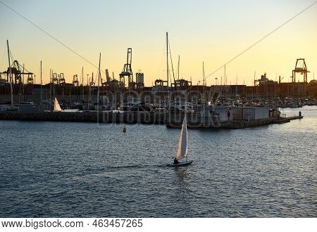 Sailboat On Sunset In Harbour. Sailing On Sea On Sailboat On The Waves. Yachtsman During Training On