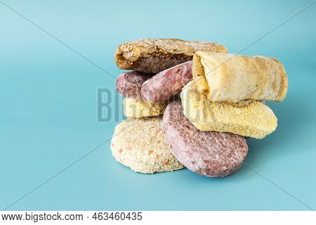 A Set Of Semi-finished Products: Pancakes, Sausages, Nuggets, Cutlets, Close-up On A Light Backgroun