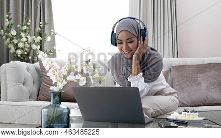 Playlist For Relaxation Portrait Of A Calm Muslim Woman In Hijab Listening To Music With Her Laptop 
