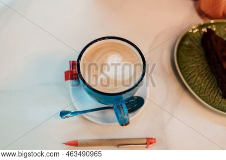 View From Above. Coffee With Milk In A Blue Cup On A Wooden Table In A Cafe