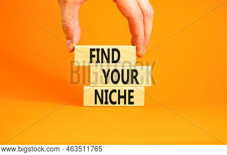 Find Your Niche Symbol. Concept Words Find Your Niche On Wooden Blocks. Businessman Hand. Beautiful 