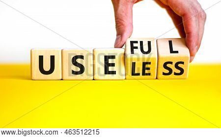 Useful Or Useless Symbol. Concept Words Useful Or Useless On Wooden Cubes. Businessman Hand. Beautif