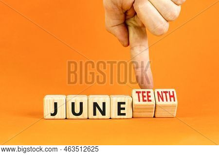 Juneteenth In June Symbol. Concept Words Juneteenth And June On Wooden Cubes. Beautiful Orange Table