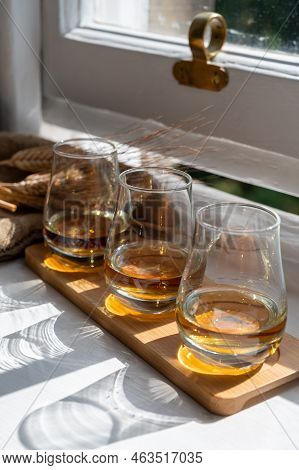 Flight Of Single Malt Scotch Whisky Served On Old Wooden Window Sill In Scottisch House In Edinburgh