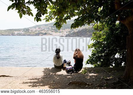 Two Student Girl Relax In Coast Vermeille Mediterranean Beach In South Coast Pyrenees Orientales In 