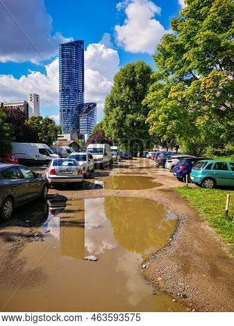 Wroclaw, Poland - September 2021: Small Parking Full Of Cars And Big Puddles With Water And Mud Next