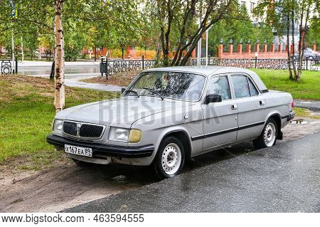 Nadym, Russia - September 4, 2022: Grey Saloon Car Gaz-3110 Volga In The City Street.