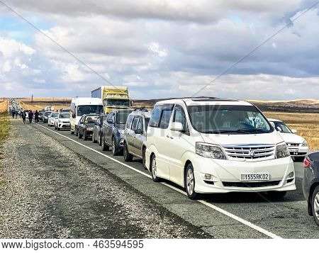 Orenburg Region, Russia - September 27, 2022: Endless Queue Of Cars Carrying People Escaping From Ru