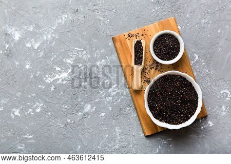 Quinoa Seeds In Bowl And Spoon On Colored Background. Healthy Kinwa In Small Bowl. Healthy Superfood
