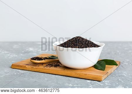 Quinoa Seeds In Bowl And Spoon On Colored Background. Healthy Kinwa In Small Bowl. Healthy Superfood