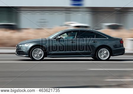 Modern Audi A6 Auto Driving Fast On The Road. Fast Moving Gray Car With Motion Blur Effect. Overspee