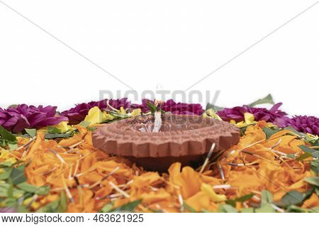 Flower Rangoli For Diwali Festival Made Using Marigold Or Zendu Flowers And Clay Oil Lamp