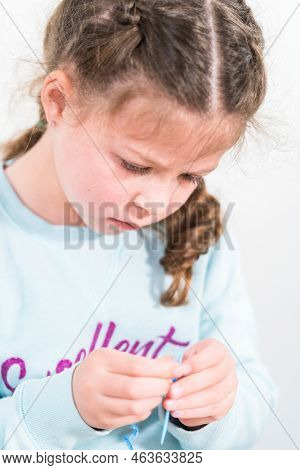 Little Girl Learning How To Sew With Sewing Craft Kit For Kids.