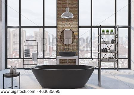 Front View On Modern Black Bath In Big Sunlit Loft Style Bathroom With Dark Metallic Furniture, Roun