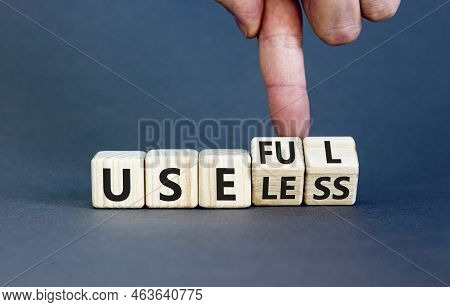 Useful Or Useless Symbol. Concept Words Useful Or Useless On Wooden Cubes. Businessman Hand. Beautif