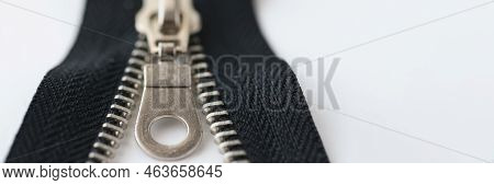 Closeup Macro Shot Of Open Black Brass Zipper Isolated On White Background. Metal Zipper Is Connecte