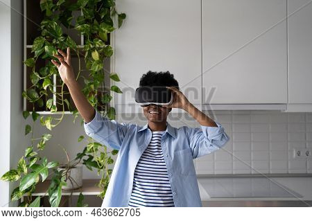 Impressed African American Woman With Hand Raised Testing Virtual Reality Headset Enjoy Immersion In