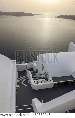 Imerovigli, Santorini, Greece - July 1, 2021: Whitewashed Houses With Terraces And Pools And A Beaut