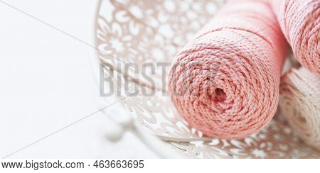 Handmade Macrame Braiding And Cotton Threads In White Basket. Cotton Macrame Cords And Ropes Against