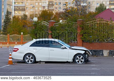 Moscow, Russia - October 08, 2022: Badly Damaged Passenger Car Stands In An Empty Parking Lot. Wreck