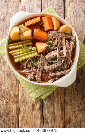 Delicious Beef Pot Roast With Potatoes, Celery And Carrots With Thyme And Rosemary Closeup In The Bo