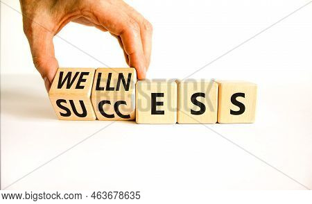 Wellness For Success Symbol. Concept Words Wellness And Success On Wooden Cubes. Businessman Hand. B