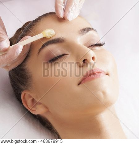 Hair Removal, Beauty And Health Concept. A Young Girl Is Getting An Epilation Procedure. A Processio
