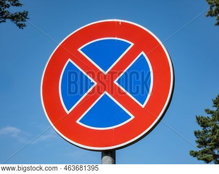 Metal Signwith A Red Circle And Red Cross Over A Blue Background Outdoors With Blue Sky In The Backg