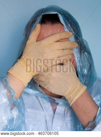 Woman In A Protective Suit Closing Her Face. Distressed Woman. Coronavirus (covid-19) Disease Outbre
