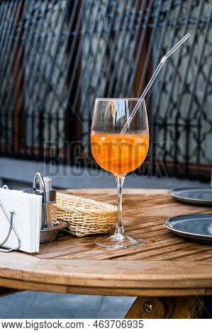Aperol Spritz Cocktail Served In A Big Wine Glass With Ice Cubes And A Drinking Straw. Summer Fresh 