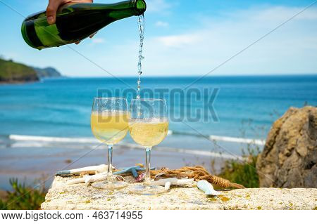 Pouring Of Txakoli Or Chacolí Slightly Sparkling Very Dry White Wine Produced In The Spanish Basque