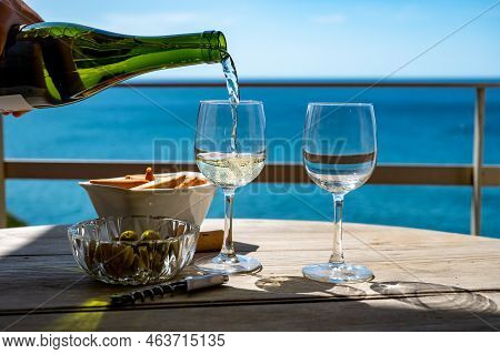 Pouring Of Txakoli Or Chacolí Slightly Sparkling Very Dry White Wine Produced In The Spanish Basque