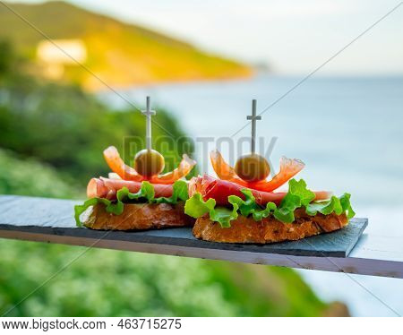 Typical Snacks Of Basque Country And Navarre, Pinchos Or Pinxtos On Skewers Served Outdoor, Bakio, S