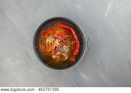 Shurpa Or Shorpa Soup On Grey Background. Top View, Copy Space. Traditional Uzbek Dish With Lamb, Ve