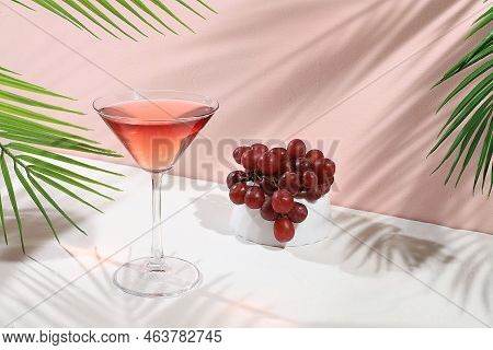 Modern Still Life With Alcoholic Margarita Cocktail And Grapes On Pastel Background With Long Hard S