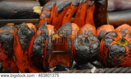 Close-up Of Peppers And Tomatoes Put On Skewers Cooked On Charcoal In The Grill. Delicious And Healt