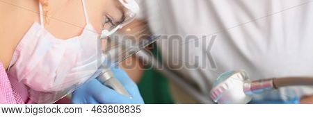 Portrait Of Woman Dentist Cure Patients Teeth On Appointment, Whitening Procedure. Special Tool Used