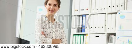 Portrait Of Presentable Employee Girl Posing Sitting On Desk In Office, Stylish Look For Work. Busin