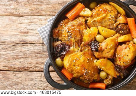 Gallo En Chicha Stew With Chicken, Prunes, Vegetables, And Spices Cooked To Have A Wonderful Flavor 