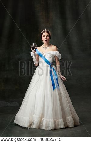 Shocked Young Charming Girl In Image Of Medieval Renaissance Person Or Viscountess Tasting Red Wine 