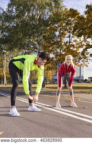 City Running Couple Having Stretching  Jogging Outside As Runners Training Outdoor Working Out While