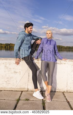 Jogging Concepts. One Positive Runners  Couple Posing Together At River Bank Outside As Runners Duri