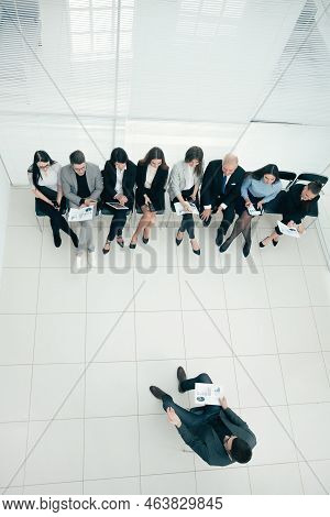 Top View. The Manager Holds A Meeting With The Business Team.