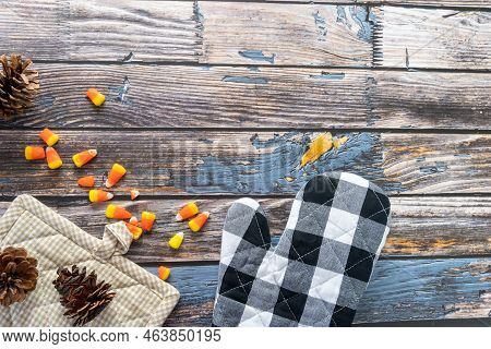 Fall Top-down Flat Lay Arrangement, Baking Theme. With Candy Corn, Plaid Oven Mitt, Pot Holder And P