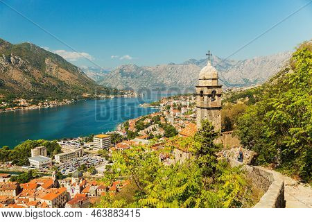 View On Church, Ancient Walls, Mountains And Sea In Kotor Old Town. Montenegro, Kotor Bay
