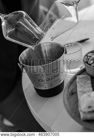 Pouring Wineglasses In Spittoon At Wine Tasting Black And White