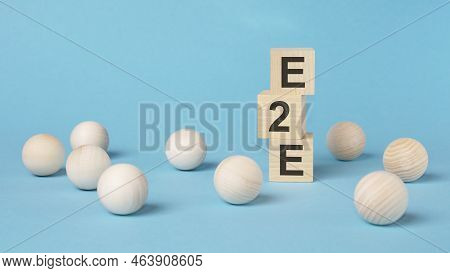 Text E2e On A Wooden Cubes On A Blue Background